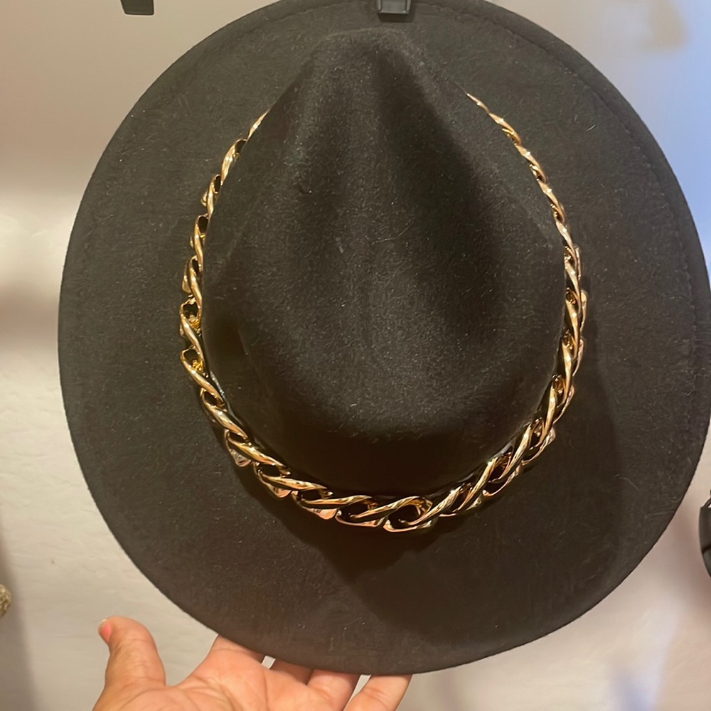 Black hat with large gold chain trim
